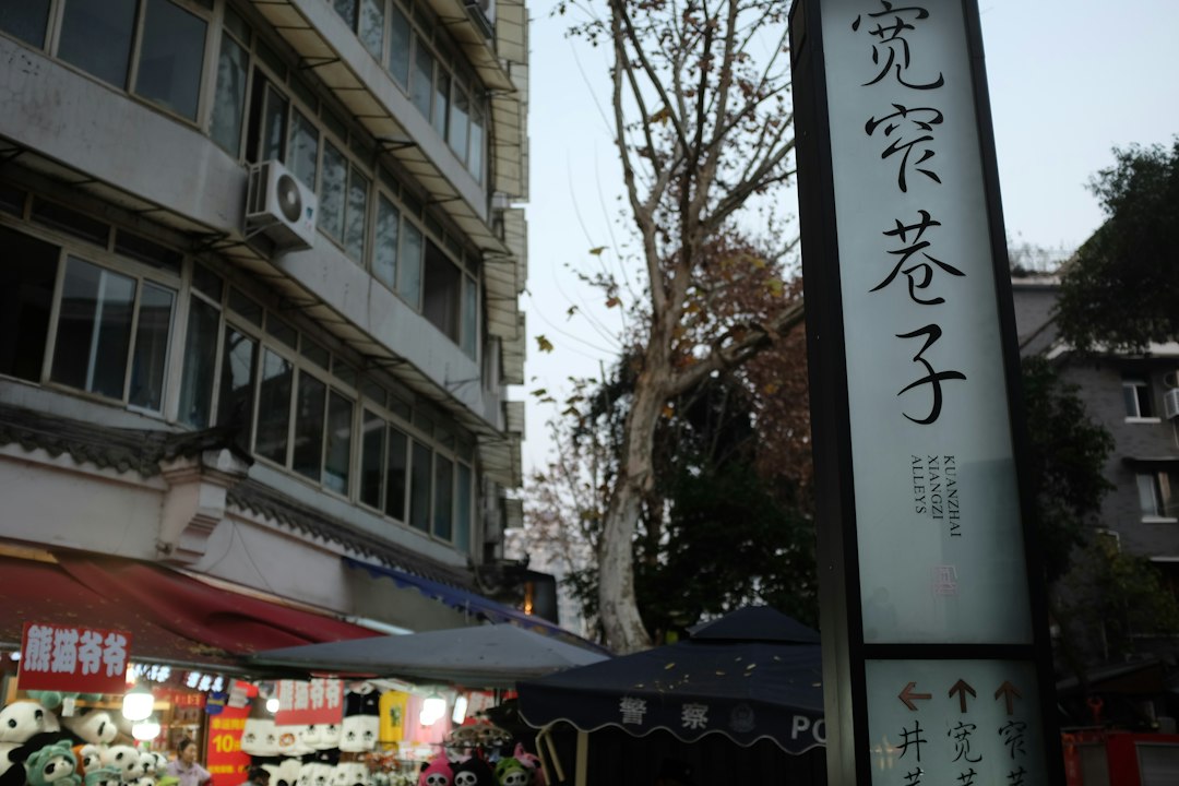 Street sign with chinese characters and shops below