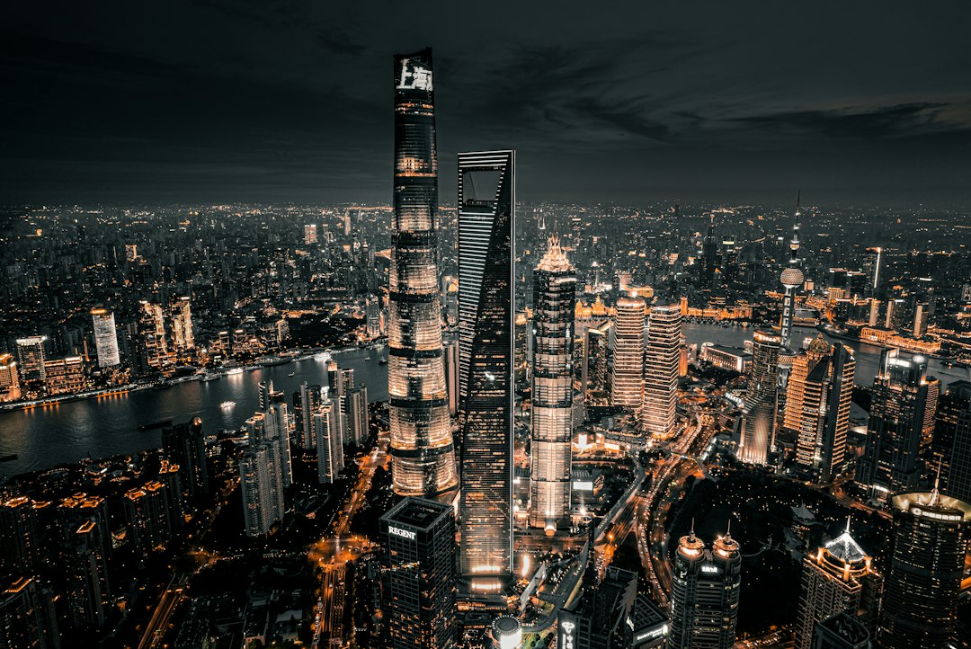 Aerial view of the illuminated Shanghai skyline at night with the Huangpu River