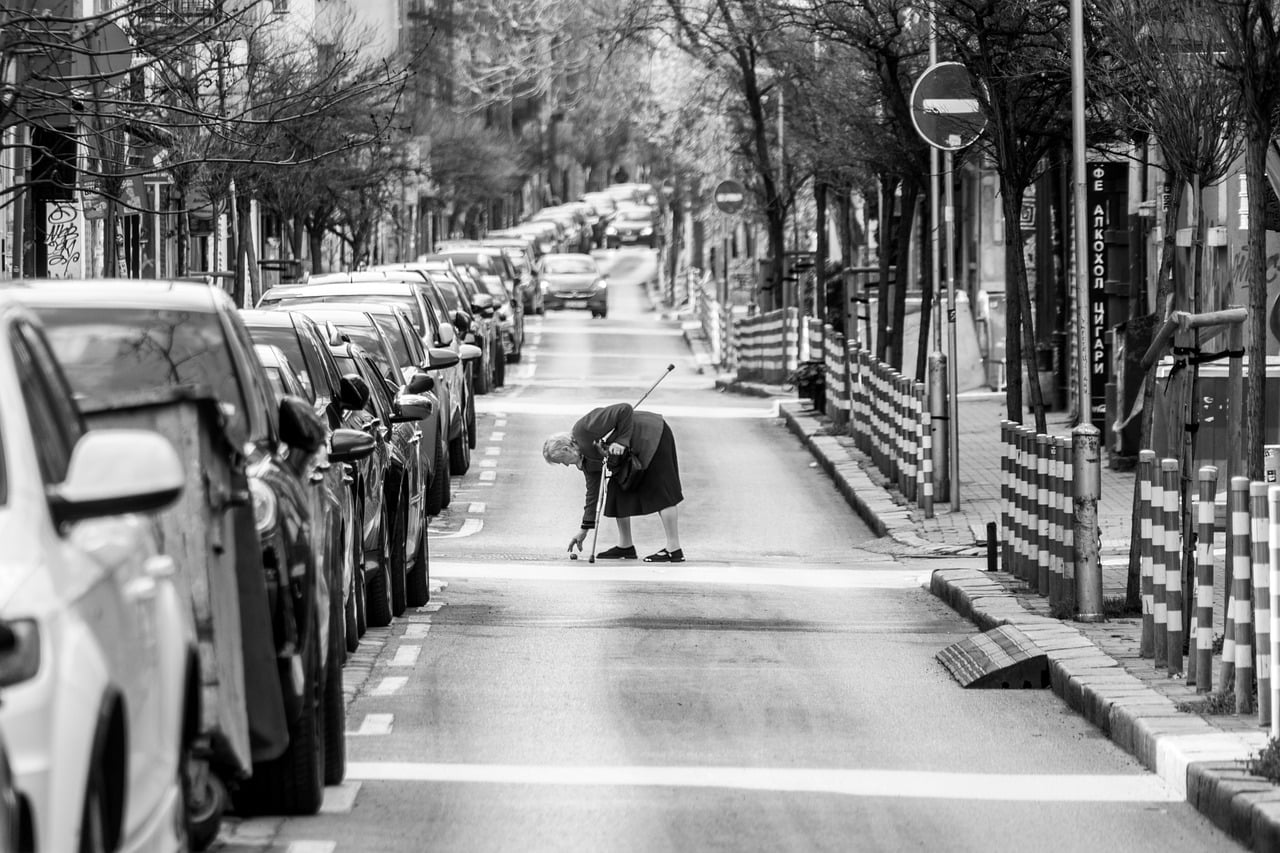 urban  black and white  elderly woman  road  puddle  rainy weather  traffic sign  car wallpapers  crosswalk  weather  parking  elderly people  busy street  city