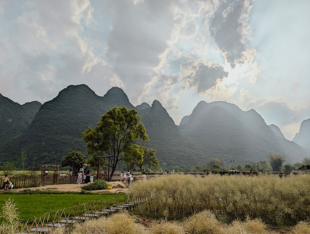 Dramatic mountains loom over a peaceful landscape