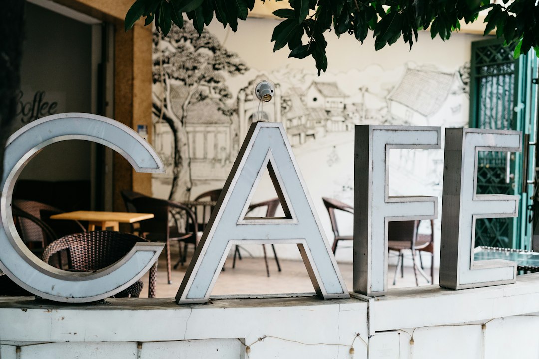 a sign that says cafe on the side of a building
