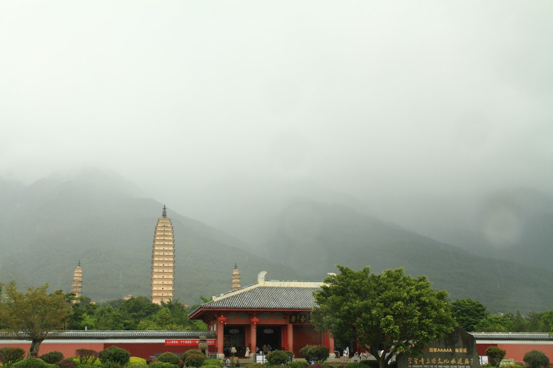 Traditional temple and pagodas against misty mountains